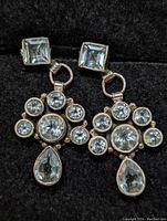 Close-up front view showing aquamarine gemstones in sterling silver setting with geometric arrangement