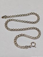 Photo of the sterling silver bracelet laid out flat showcasing the chain design and clasp.