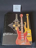 Front cover of the hardcover guitar book showing three electric guitars on a black background titled 'guitar' by Terry Burrows.