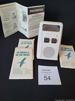 Mini vinyl record player with instruction brochure and three packs of bird sound recording mini records laid out for display