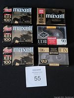 Six new Maxell cassette tapes in sealed packages, three XLII-S 100-minute and three UDII 90-minute tapes shown from front and side.