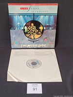 Front view of the Pink Floyd In Concert LaserDisc and the media disc in paper sleeve.