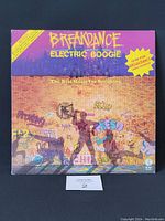 Front cover of 'Breakdance Electric Boogie' vinyl record showing graffiti-style artwork and breakdancer silhouette.