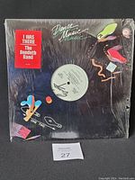 Front view of vinyl record in shrink wrap with a red sticker reading 'I Was There The Bendeth Band' and colorful abstract designs on sleeve.