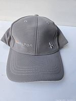 Front view of gray baseball cap showing Hamilton name and star logo pin