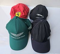 Four caps displayed together showing all brands and colors.