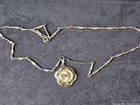 Full view of the Vendome necklace watch laid flat showing chain and pendant.