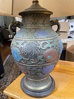 Full view of Asian-style vase lamp showing floral enamel work and base.