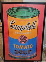 Full view of the framed colorful Campbell's Soup poster print by Andy Warhol, showing the entire artwork and frame.