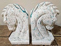 Front view of mid-century speckled ceramic horse head bookends showing detailed horse features and speckled glaze.