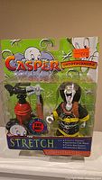 Front view of new Casper Ghostformers Stretch action figure in original packaging with a clear plastic window showing the figure and accessories including fire extinguisher and axe, packaging reads 'Try Me! for sounds'
