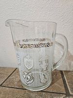Full view of the clear glass pitcher showing pattern and shape