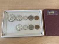 Photo showing the 1956 US Mint coin set with all coins visible inside a clear plexiglass case and the original maroon box on the side