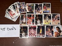 Photo showing 45 basketball cards displayed spread out on a table alongside a handwritten note '45 Card's'