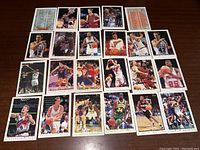 Photo showing 24 different 1995 Topps basketball cards laid out in a grid, displaying player images and card fronts.