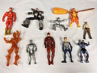 10 assorted superhero action figures displayed on white background