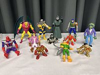 Full group of 12 action figures on display showing different character designs and colors.