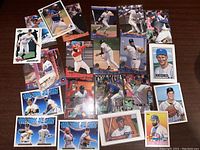 Photo showing 22 assorted baseball cards featuring various players in different poses and teams
