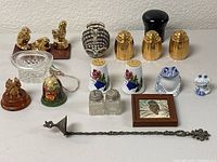 Full view of all decorative items: salt and pepper shakers, figurines, clear glass bowl, framed bird picture, and candlesnuffer