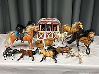 Overview of all 13 horse/figures along with Sunny Trails Farms horse carrier and 3 horses inside
