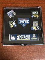 Full view of the 2020 Los Angeles Dodgers commemorative 6-pin set in black display case showing all pins and central plaque with edition number