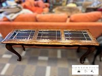 Full view of oak console table showing three leaded glass panels on top and carved cabriole legs.