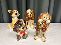 Front view showing all 5 porcelain dog figurines arranged in a group