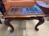 Top view of the darkwood end table showing the wood frame and two beveled glass panels with metal outlining grid pattern.