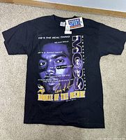Front view of a black Randy Moss T-shirt featuring a large graphic print with text and a portrait of Randy Moss, indicating it is from 1998.