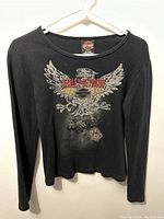 Front view of black Harley Davidson long sleeve shirt with eagle graphic and Harley Davidson text on front.