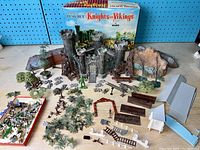 Full overview of the Marx Knights and Vikings miniature play set showing all components including castle, catapults, trees, fences, ladders, rocks, and figures.