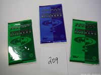 Three unopened packs of Batman Forever Movie Photo Stickers, two green and one blue.