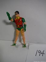 Full view of Robin action figure in classic costume, standing with right hand raised in karate chop pose.