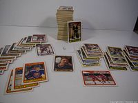 Wide view showing multiple stacks and spreads of hockey cards including Kirk McLean and other players.