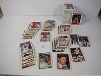 Multiple stacks and groups of 1991 OPC hockey cards spread out on a surface, showing variety of players and card designs.