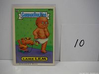 Front of Garbage Pail Kids trading card 497a featuring Lame Lem character with green background and dog on leash