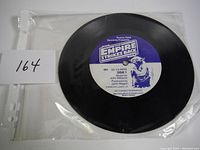 Photo showing the original Star Wars The Empire Strikes Back 7-inch record in plastic sleeve with lot number 164.