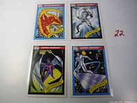Four Marvel Super Heroes trading cards featuring Human Torch, Havok, Archangel, and Silver Surfer placed on a white background with a handwritten number 22.