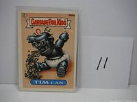 Front side of Garbage Pail Kids Tim Can card #484a showing the illustrated character vomiting.