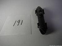 Front view of black die cast Batmobile model highlighting front design and overall shape.