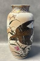 Side view of the vase displaying more of the painted design and general shape.