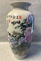 Front angle showing floral painting and Chinese calligraphy on porcelain crackle glaze vase.