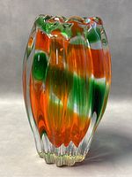 Full view of the vintage Narumi/Sanyu fantasy glass vase with colorful swirls of orange, green, and white within clear ribbed glass.