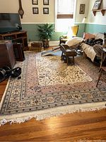 Wide view of the large area rug in a living room setting, showing overall pattern and placement.