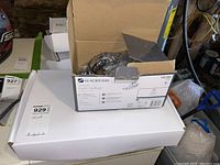 Box of Glacier Bay Aragon bath faucet on top of white box in basement setting