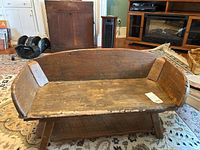 Front view showing curved backrest, curved side panels, seat boards and lower shelf