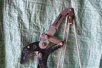 Close-up of the black and silver metal pruner head with visible Craftsman logo and rope system attached for cutting.