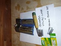 Lot contents including hollow punch set in blue fabric holder, Richards utility cutter, and two boxes of replacement blades.