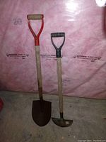Red handled shovel and Yardworks edge cutter standing against insulated wall