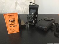 Kodak Junior Six-20 camera with leather carrying case and sport glasses box visible